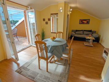 green apartment, living room, LCD TV with satellite channels, sofa, dining room