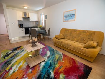 yellow apartment, living room, LCD TV with satellite channels, sofa, dining room