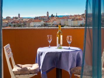 blue apartment, balcony, view of the old town of Rab, table and chairs