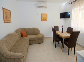 red apartment, kitchen table, LCD TV with satellite channels
