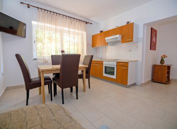red apartment, kitchen table, LCD TV with satellite channels